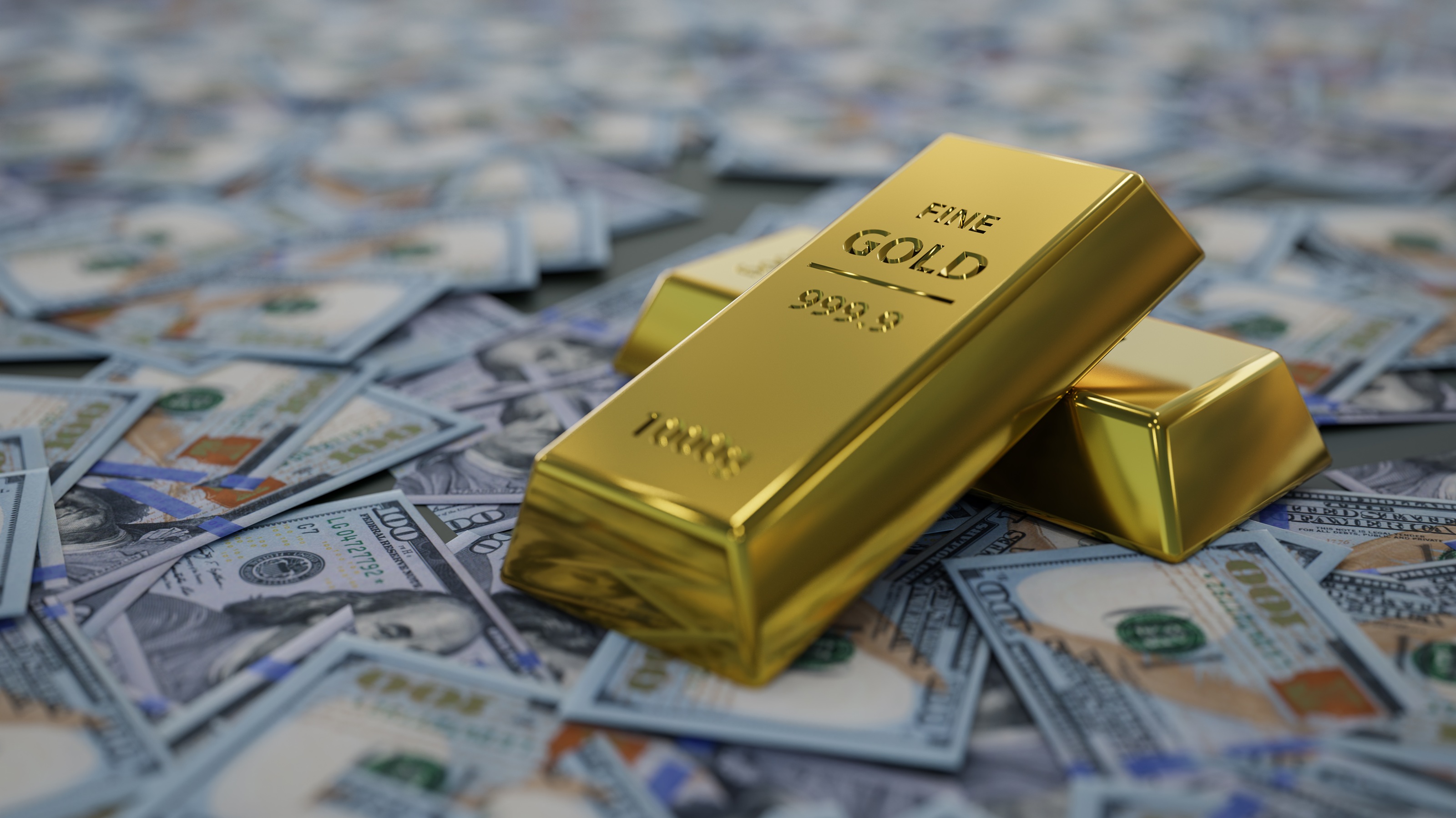 Physical gold bars sit on top of scattered US dollar bills.