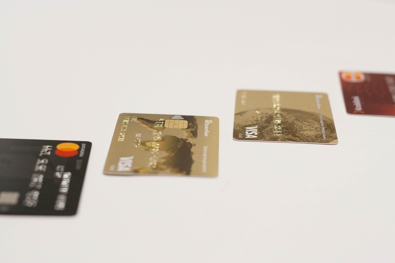 A pair of scissors cutting a blue plastic credit card in half to represent financial liberation.