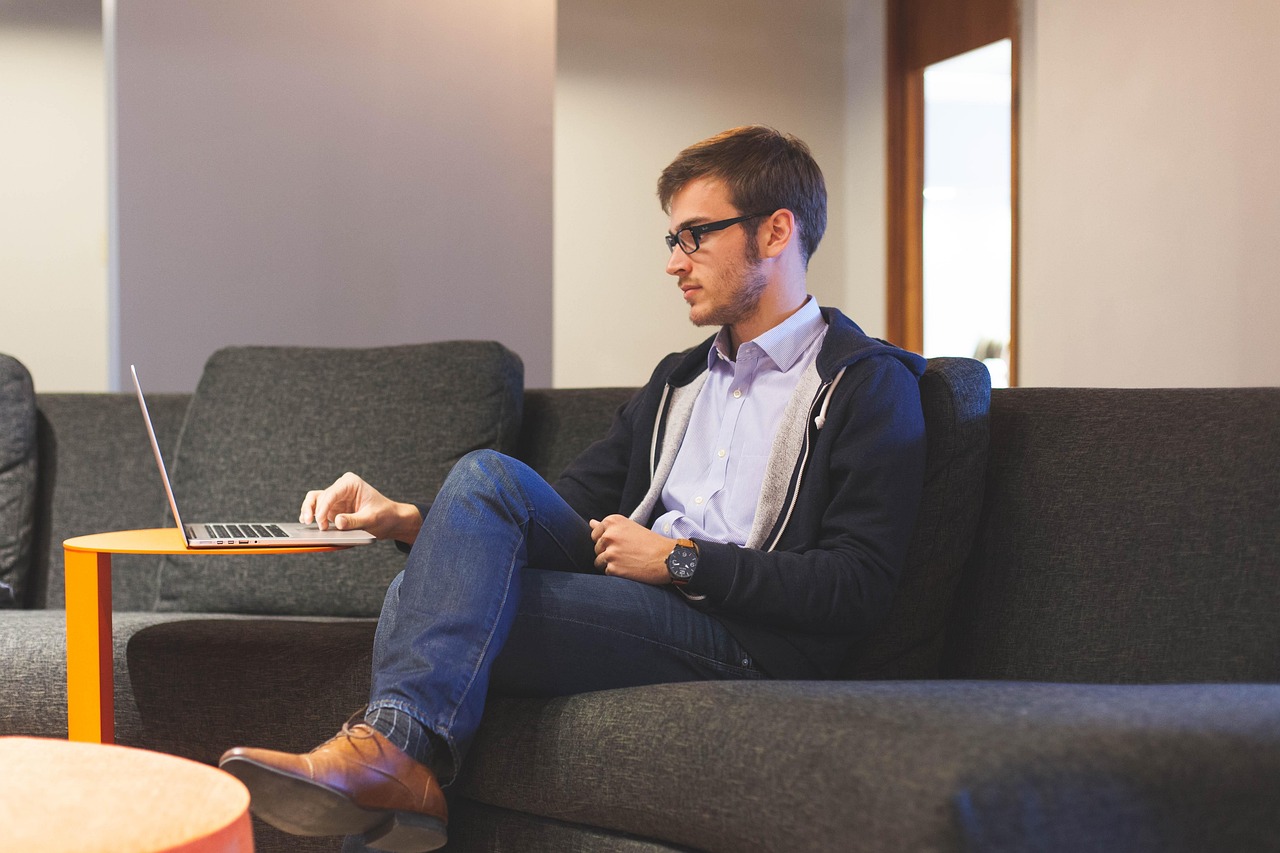 A professional man reviewing financial details on a laptop.
