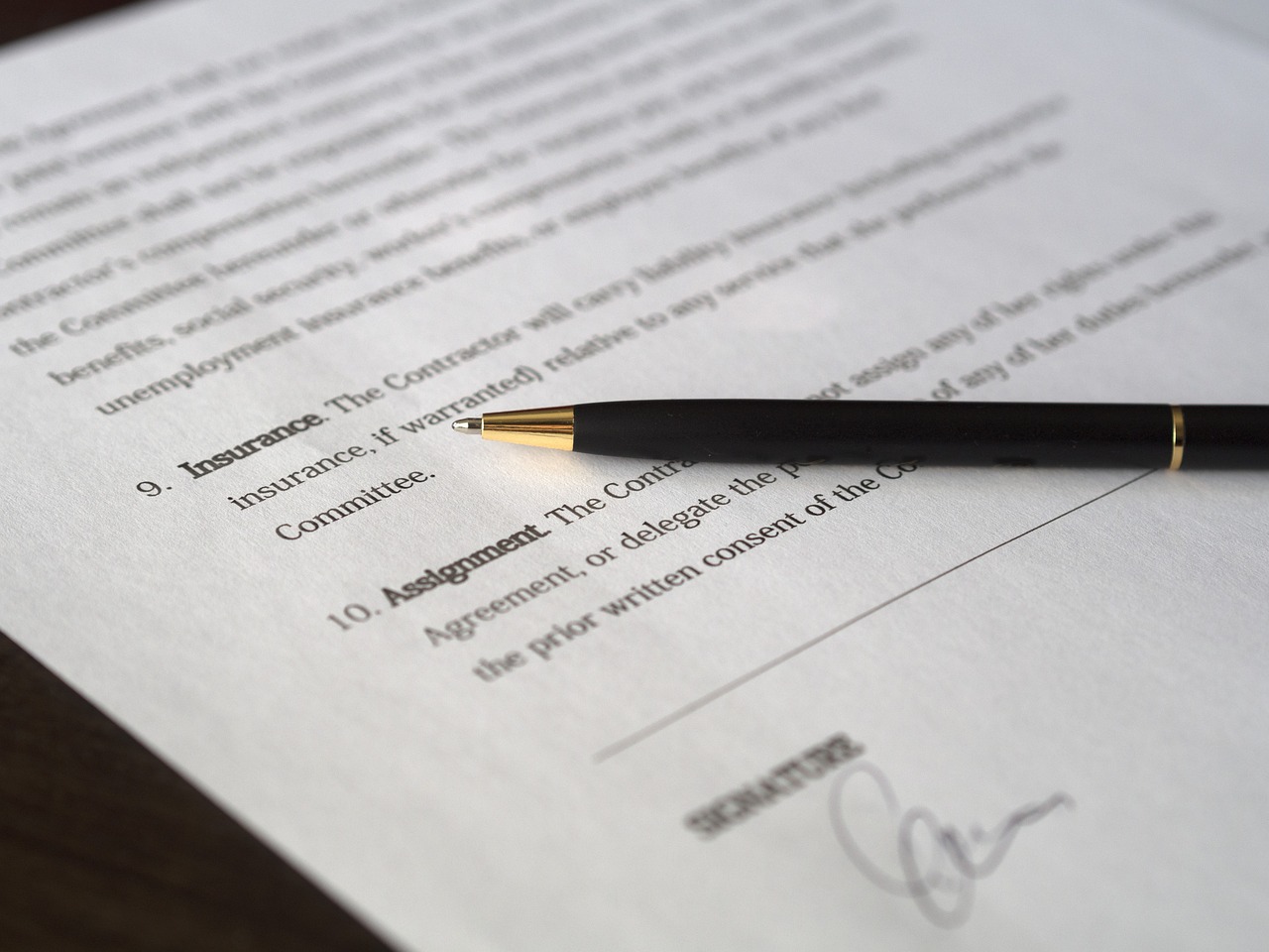 A close up of an insurance policy declaration page with a pen