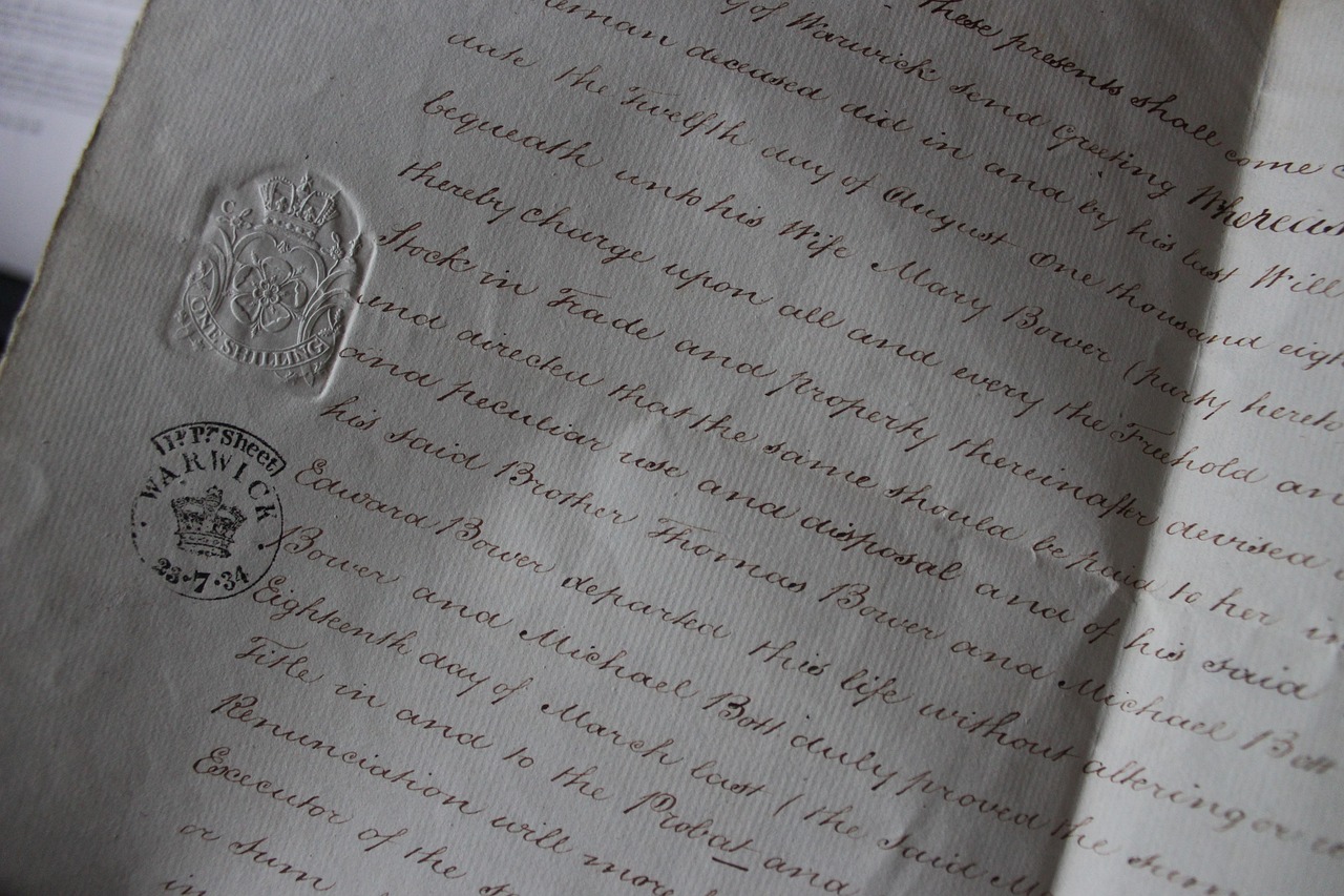 A close-up of a person signing a legal document with a pen.