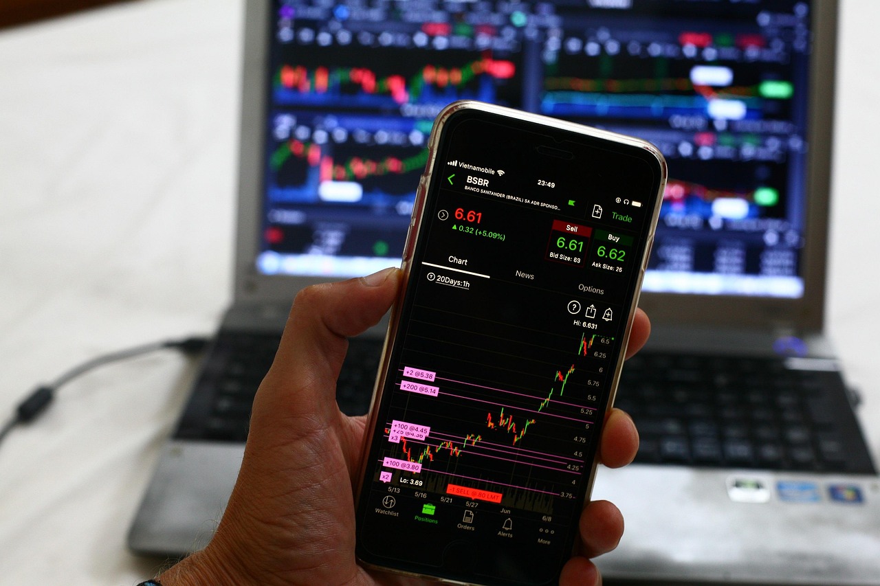 Hands holding a smartphone displaying financial growth data.