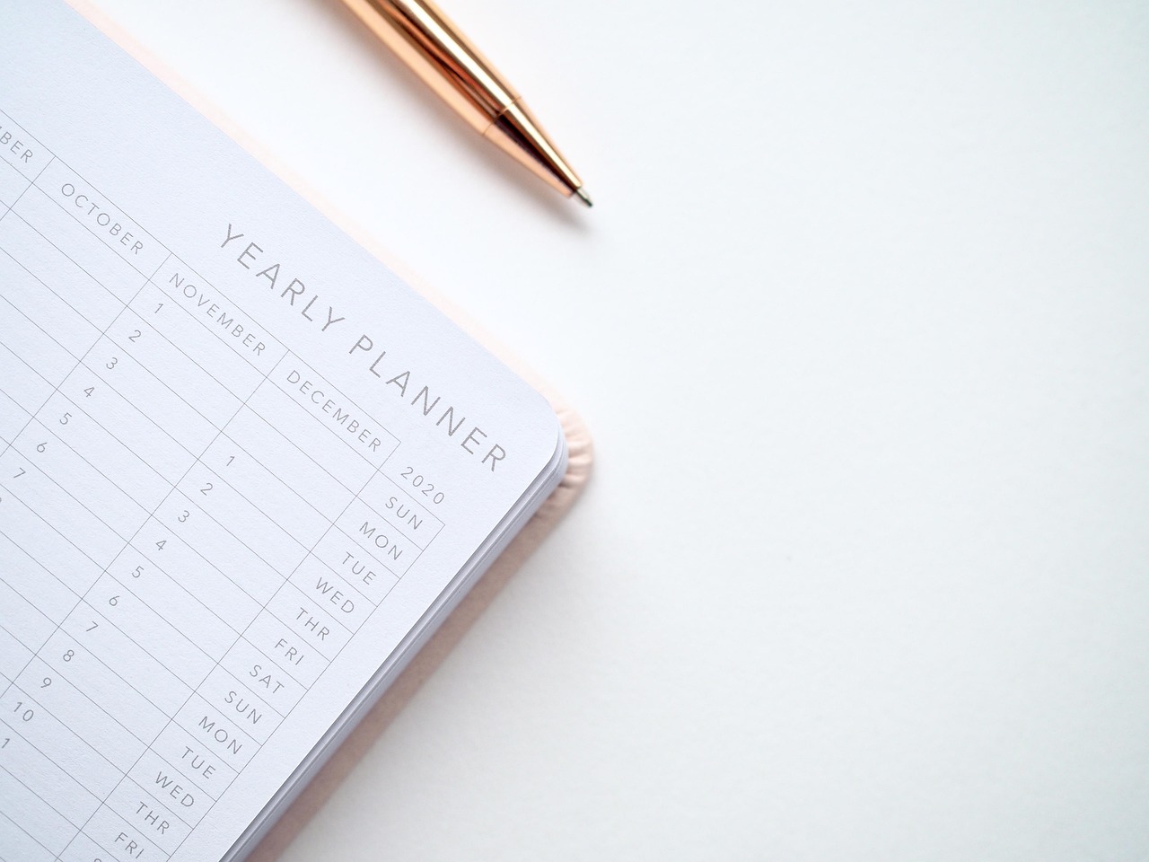 A close-up of a calendar and a pen, symbolizing the strategic timing of financial requests