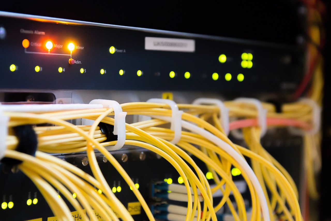 Rows of blue-lit server racks in a modern professional data center facility.