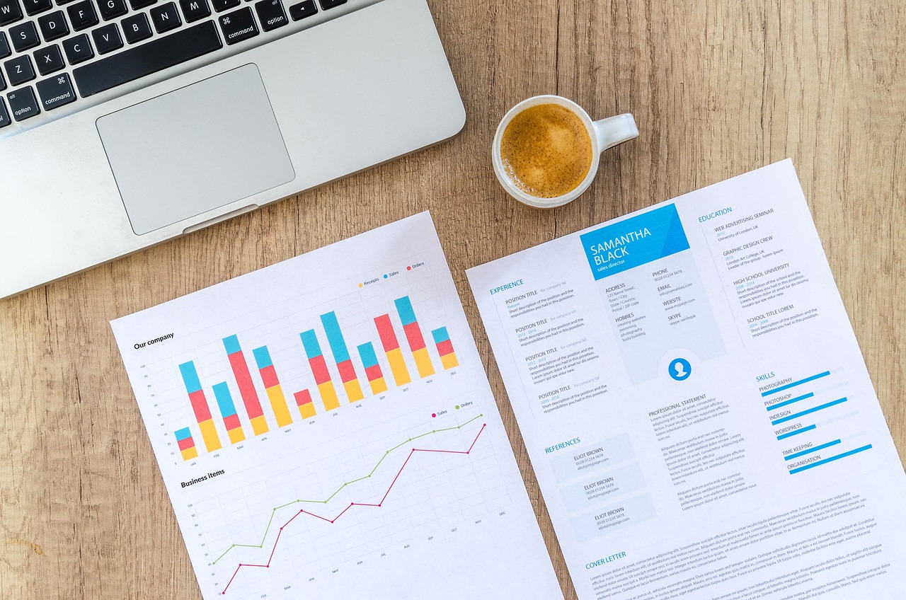 A laptop screen showing financial data and comparison charts.