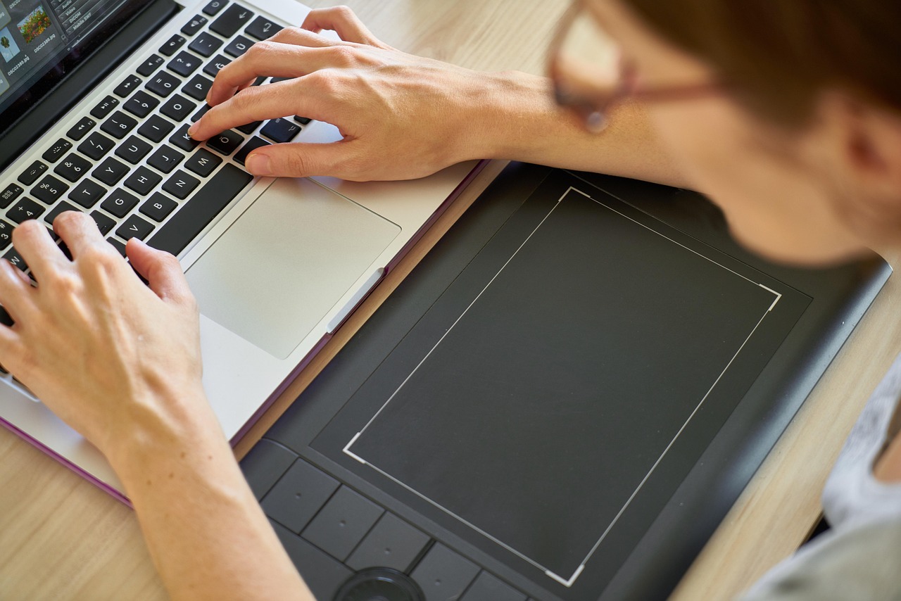 A person adjusting settings on their laptop computer to enable cookies and JavaScript.