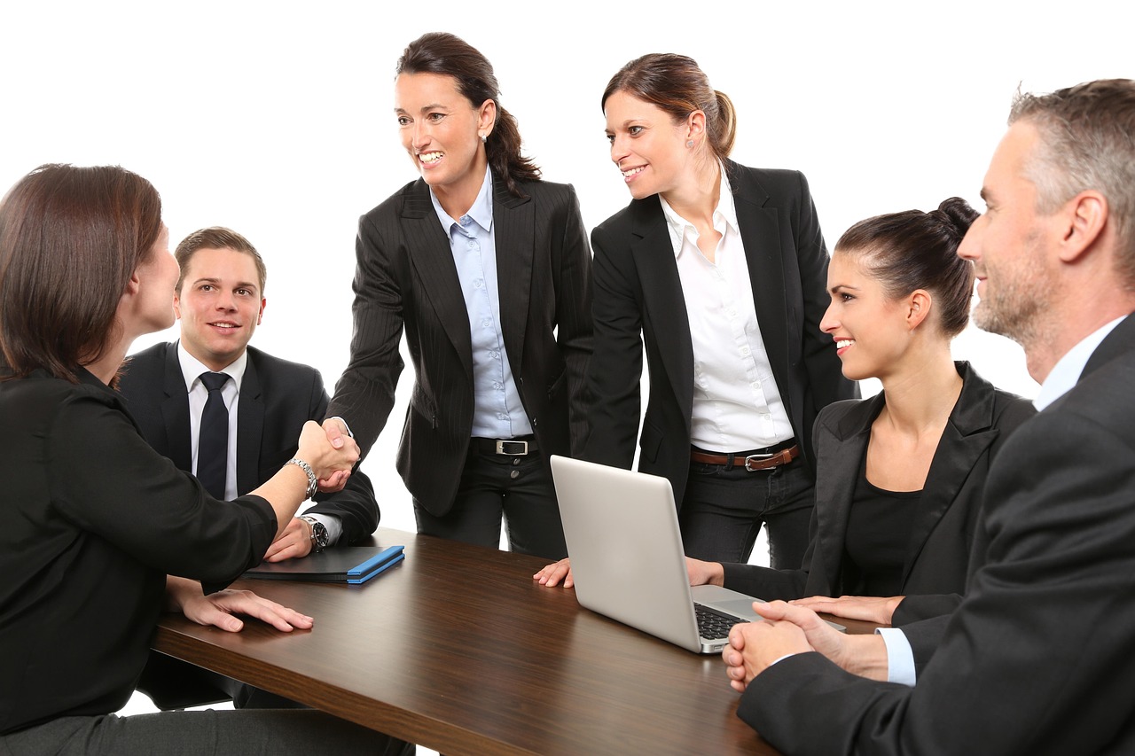 A firm handshake between two professionals in a brightly lit office.