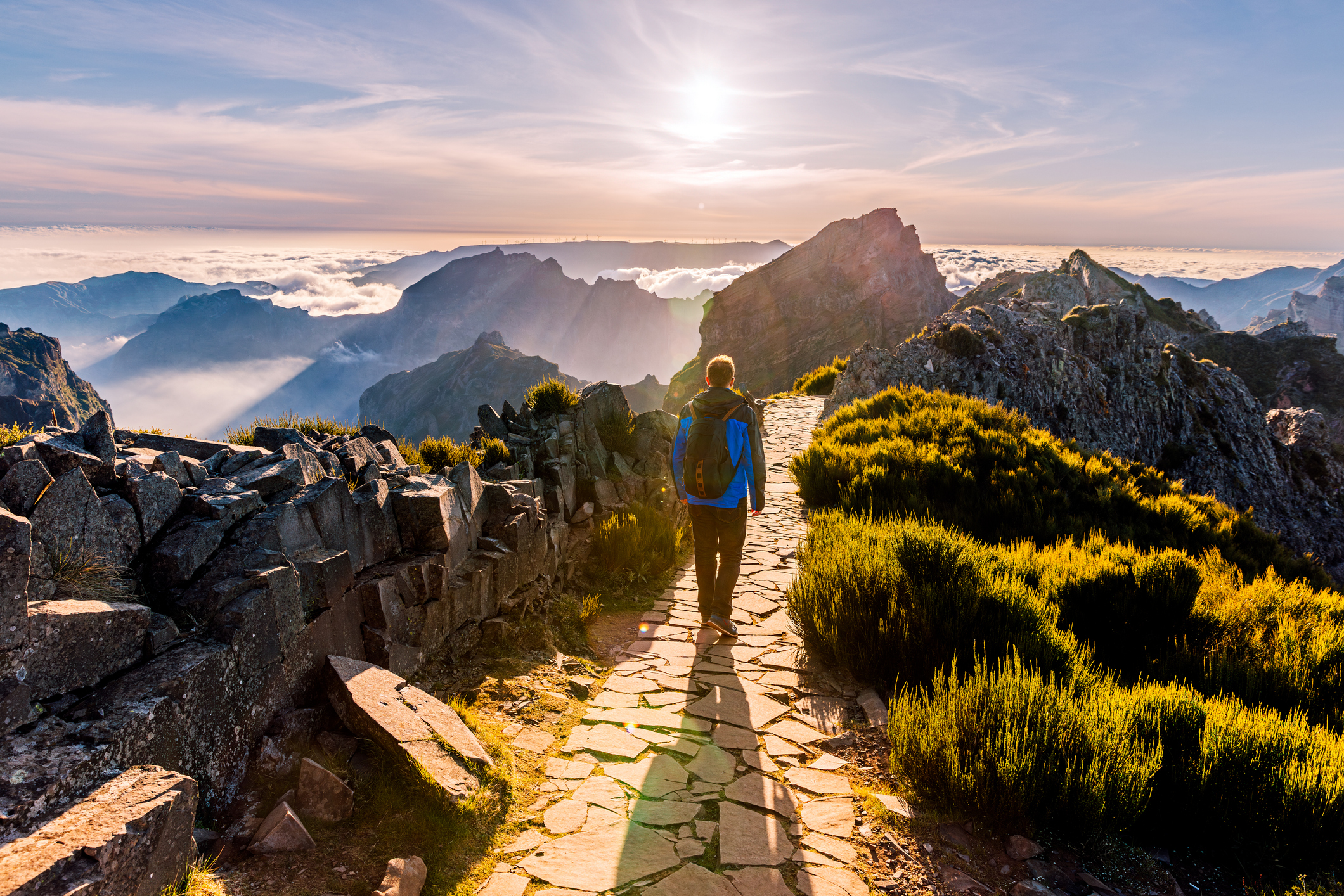 A person hiking along a mountain ridge, representing progress and achievement.