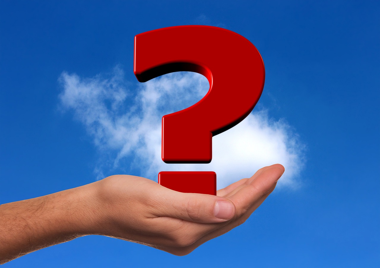 Stylized question marks on wooden blocks symbolizing frequently asked questions