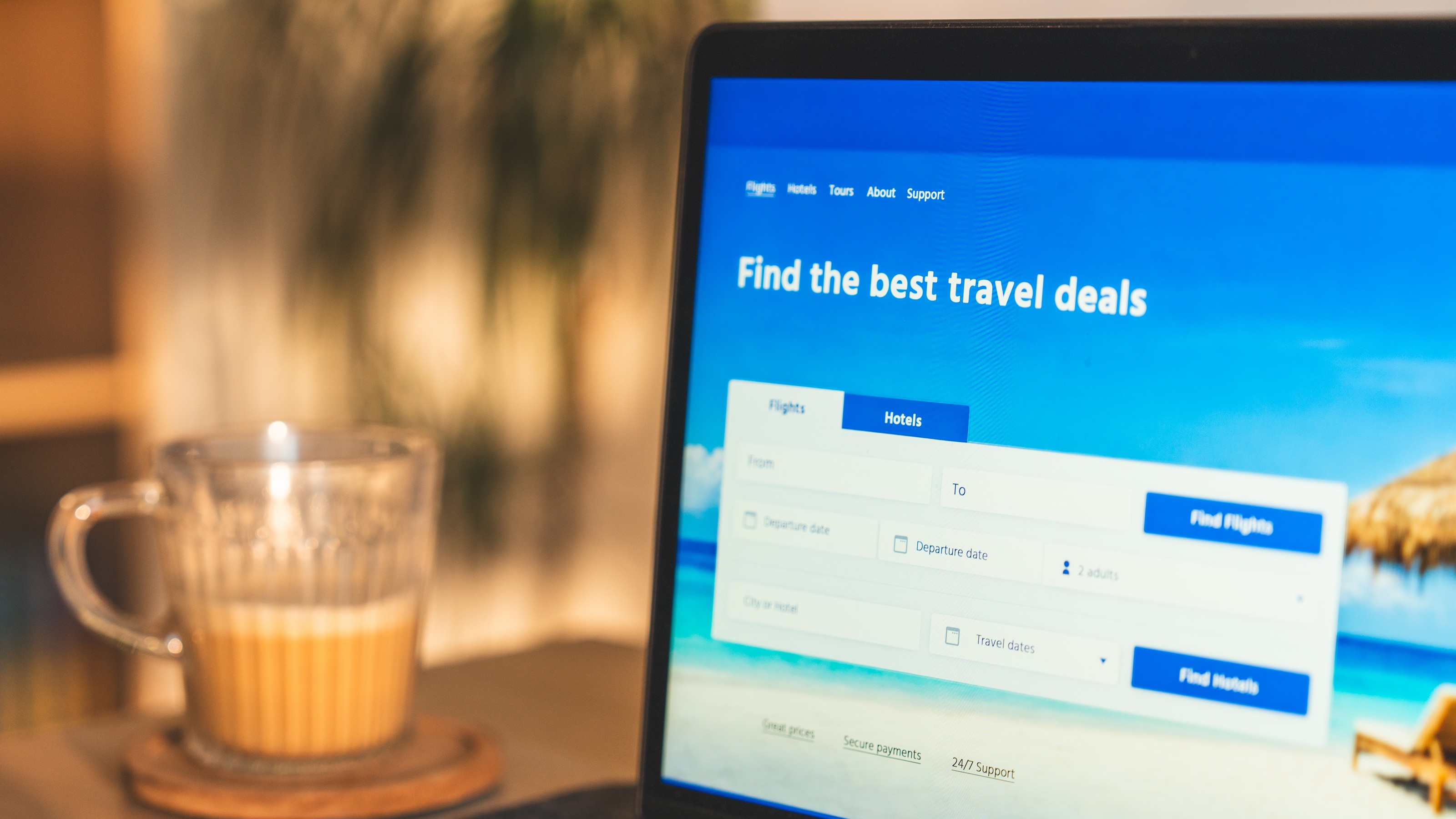 A laptop showing a website for finding the best travel discounts and financial deals.