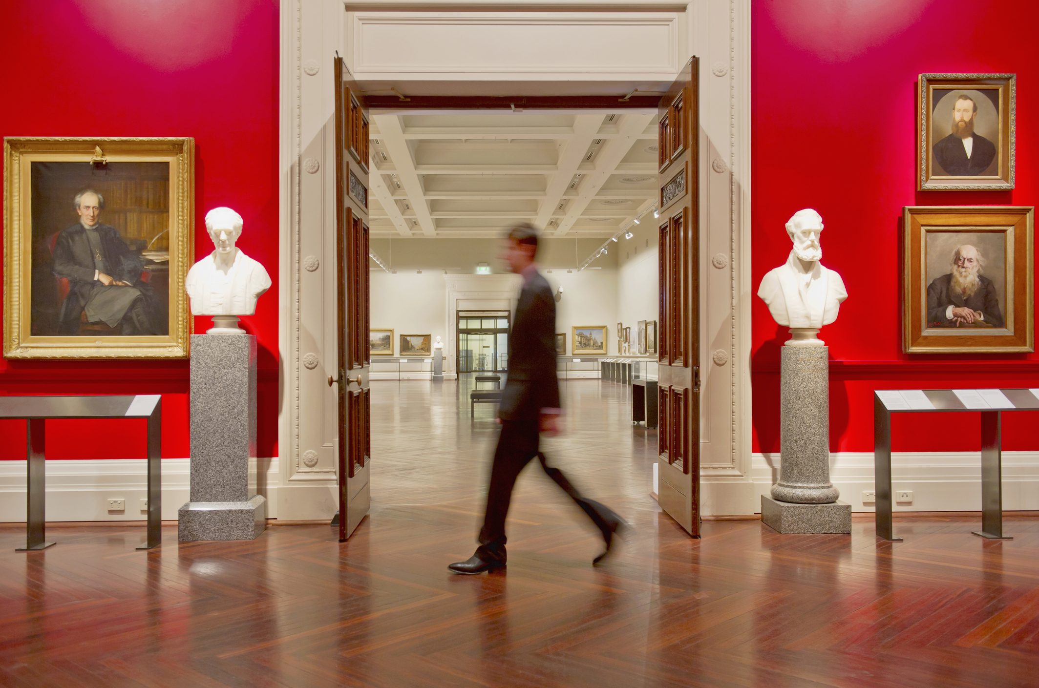 Blurred interior of an art museum representing professional high-value asset storage and privacy.