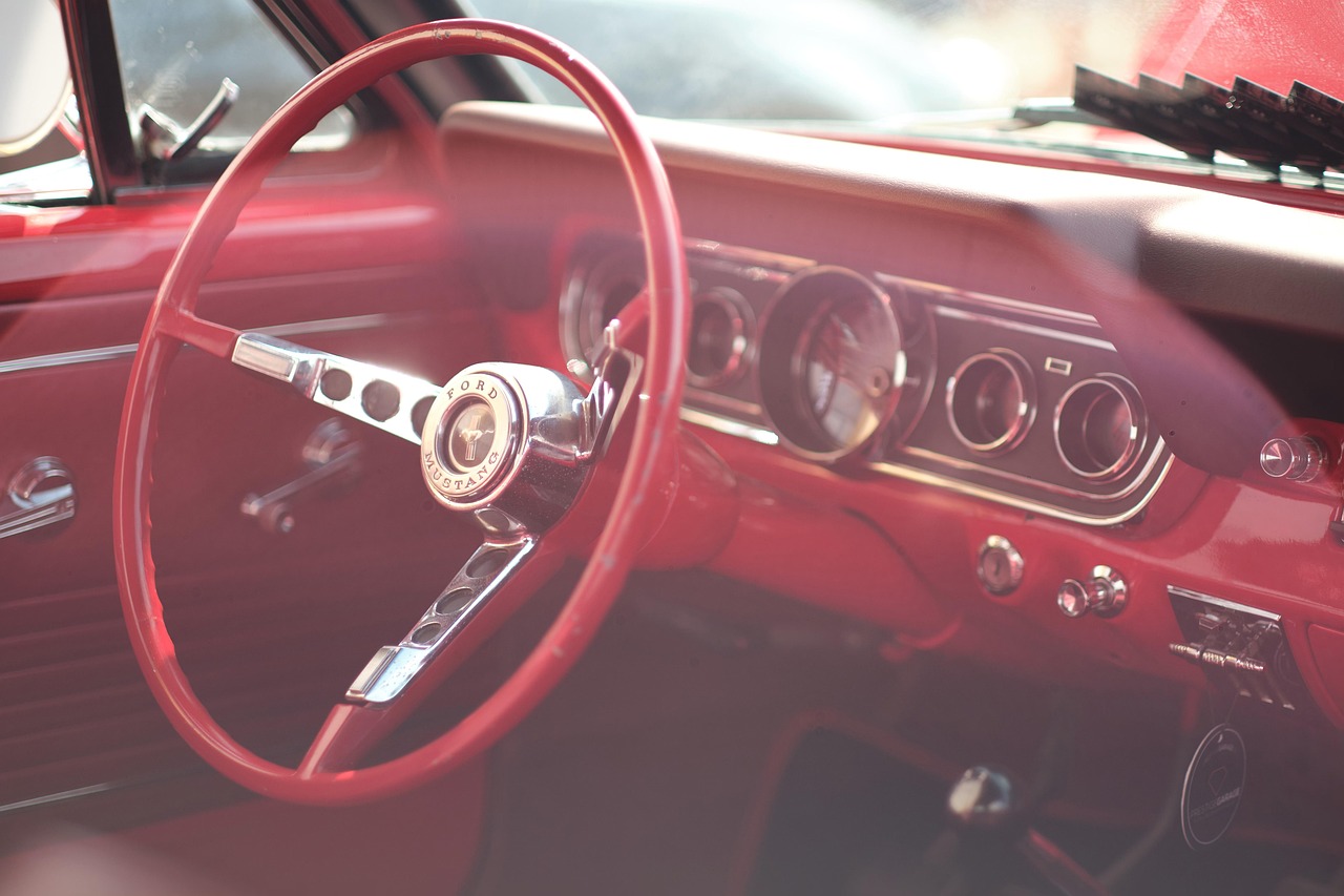 View from the driver's seat of a modern car showing the steering wheel and dashboard.