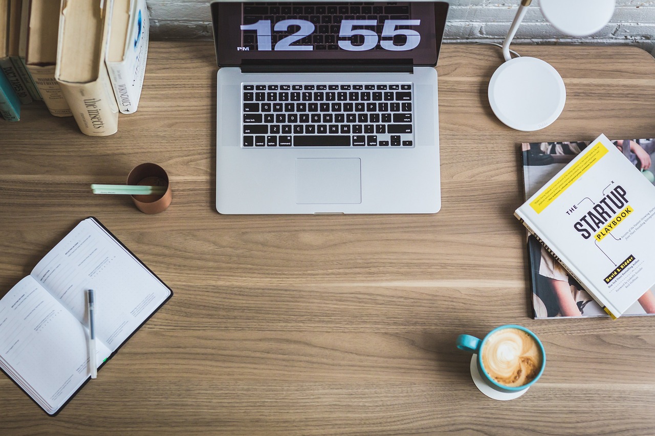 A professional desk setup featuring a calendar and a watch to represent the 181-day waiting period.