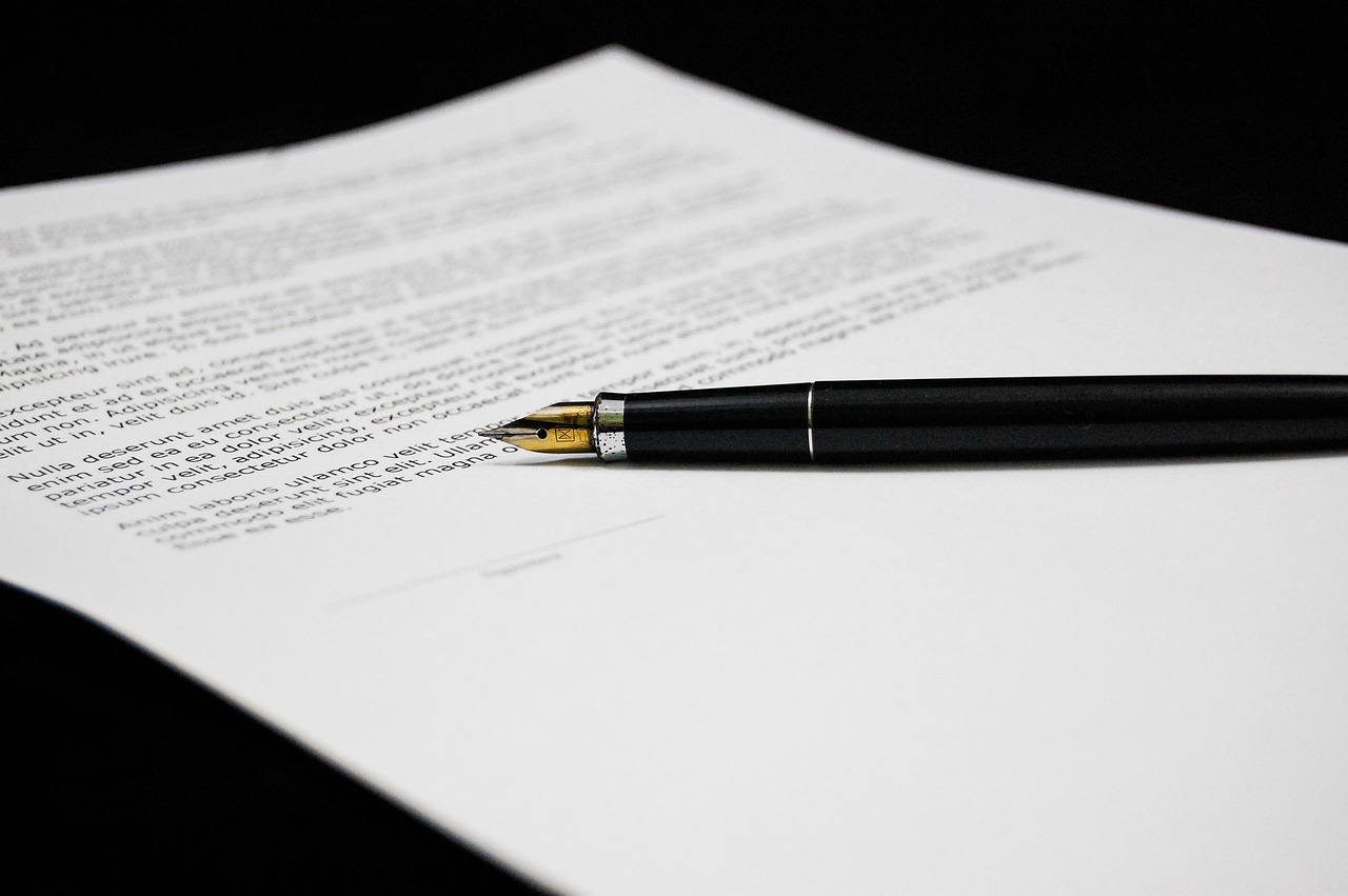Insurance claim forms on a desk with a pen and a calculator