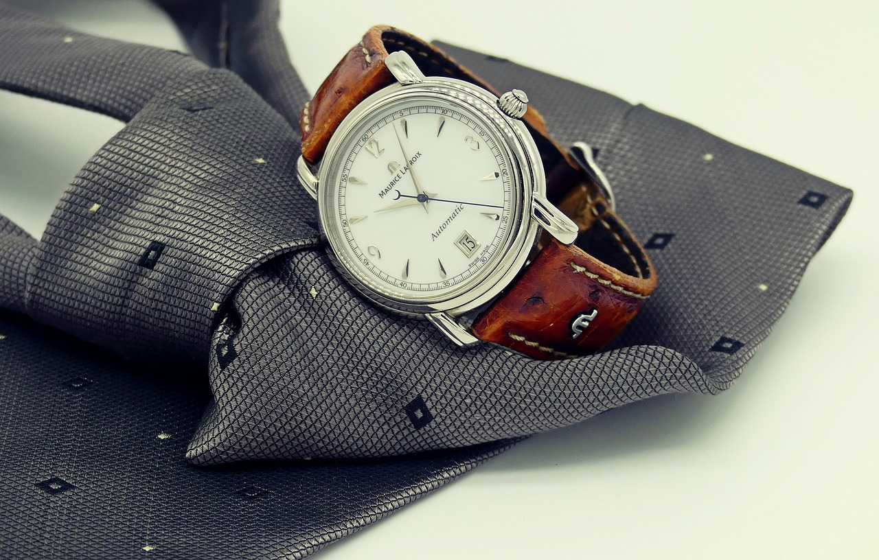 A close-up of a person wearing a simple, inexpensive watch and a basic wedding band.