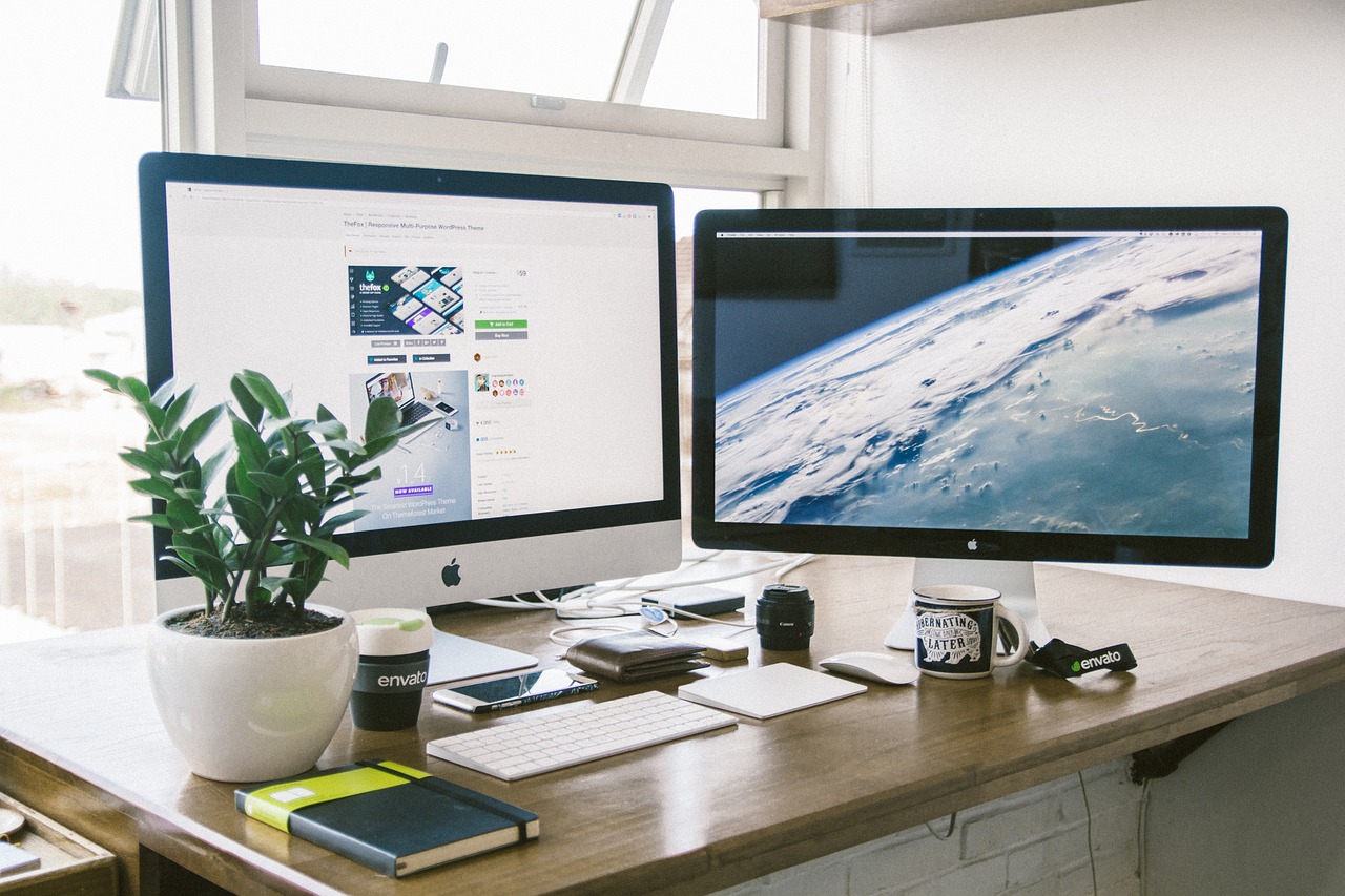 A clean, organized desk with a notebook, pen, and a small green plant