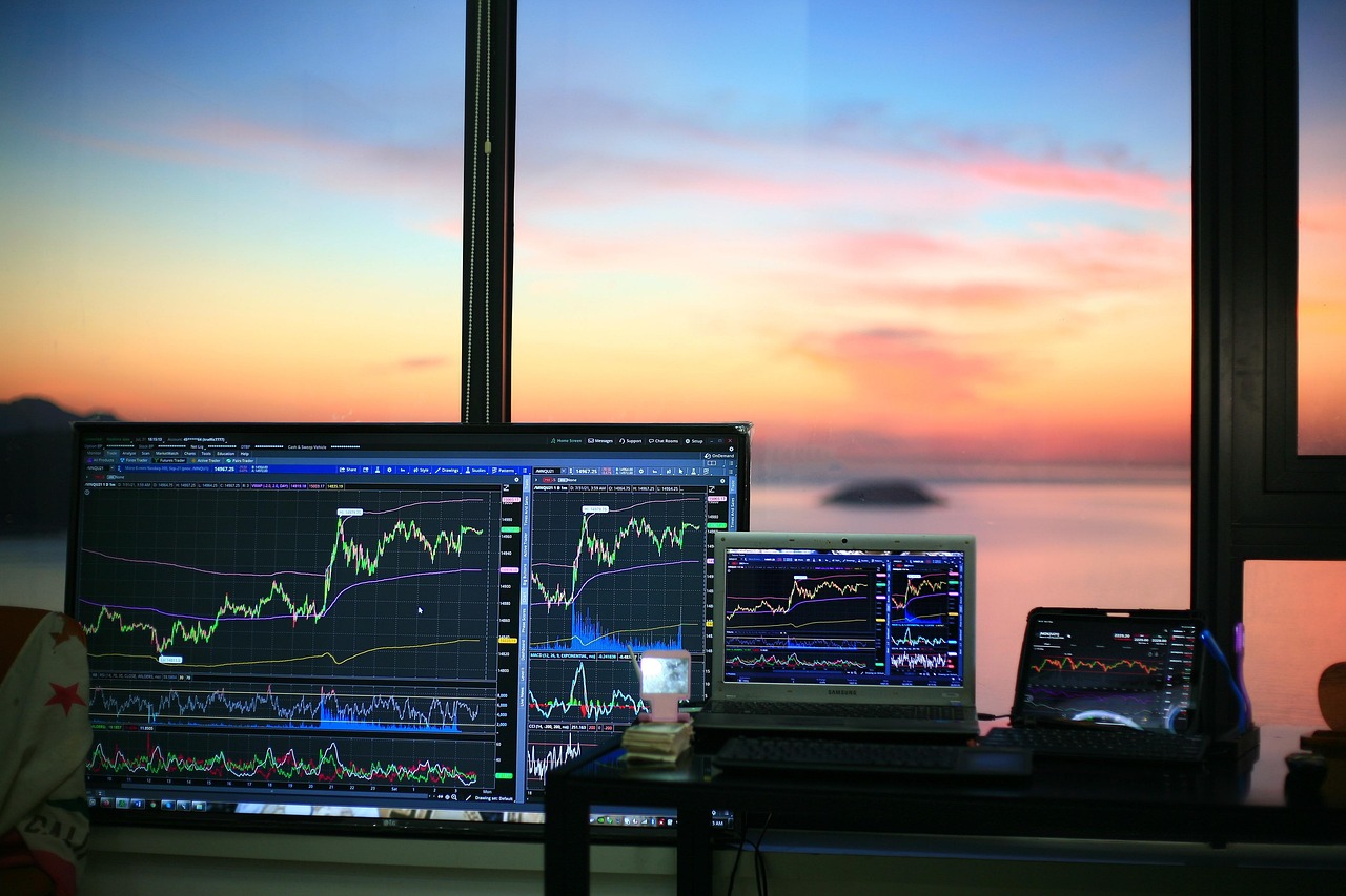 A digital display showing upward trending stock market indices.
