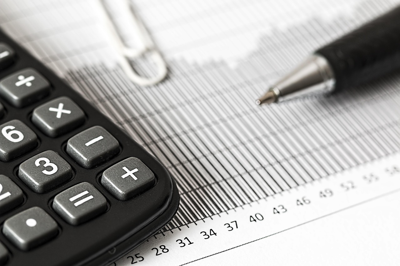 A close-up of financial forms and a pen, suggesting the income verification process.