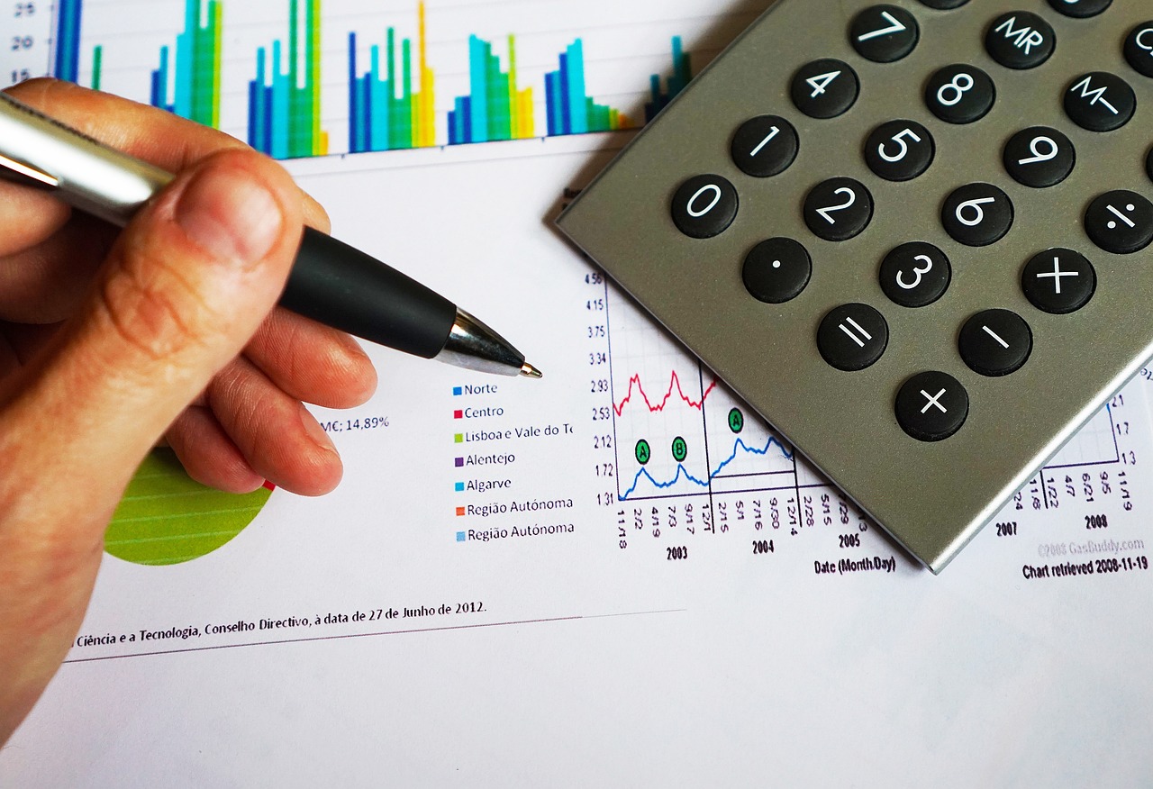 A calculator and financial documents on a desk illustrating credit eligibility assessment.