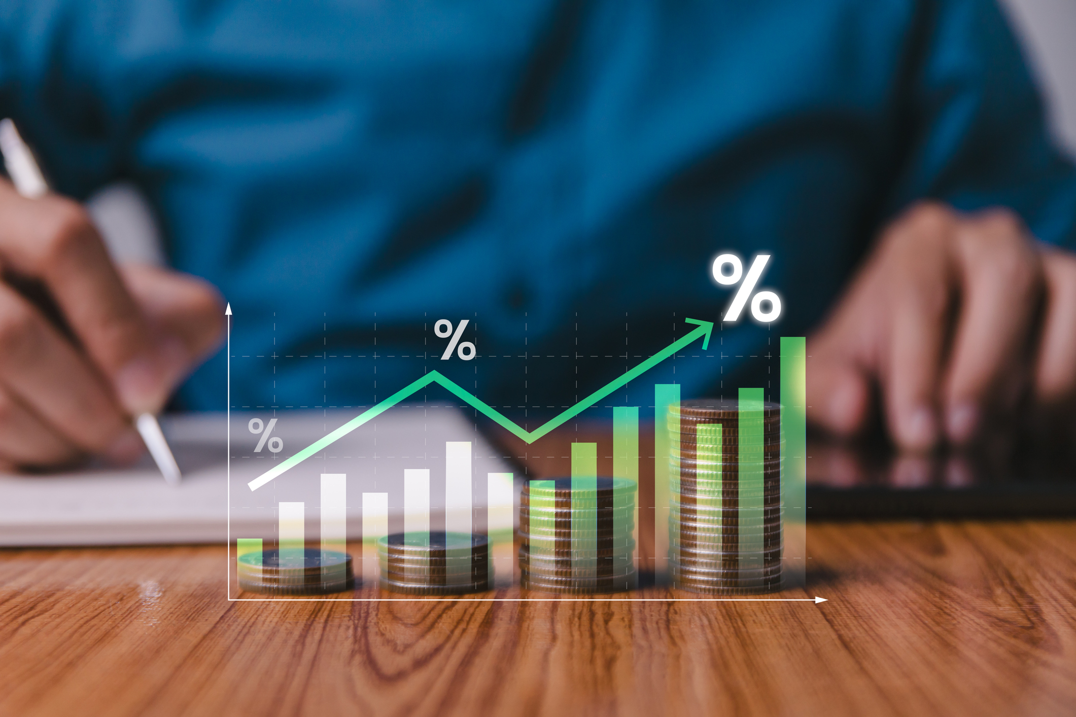 A financial line graph and bar chart overlaid against stacks of growing coins.