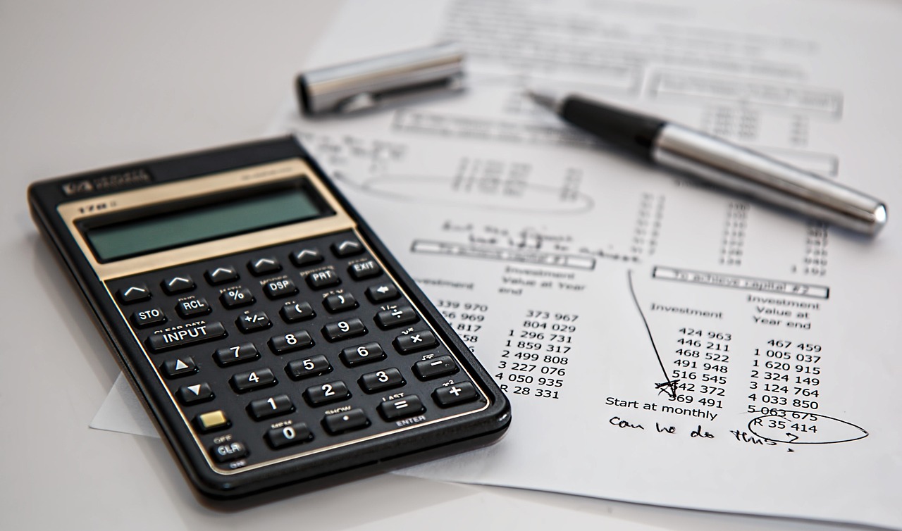 A close-up of an insurance policy document with a fountain pen resting on the signature line.