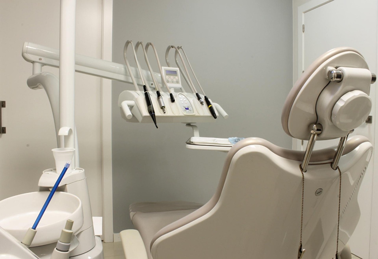 A dentist reviewing a 3D CBCT scan of a jaw for dental implant precision.