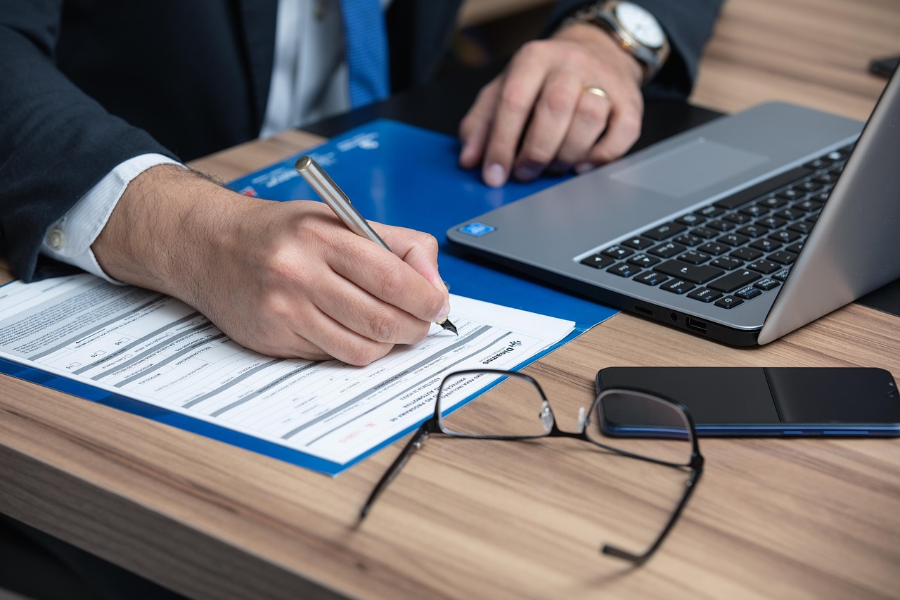 A close-up of a fountain pen resting on a signed legal document or corporate certificate.