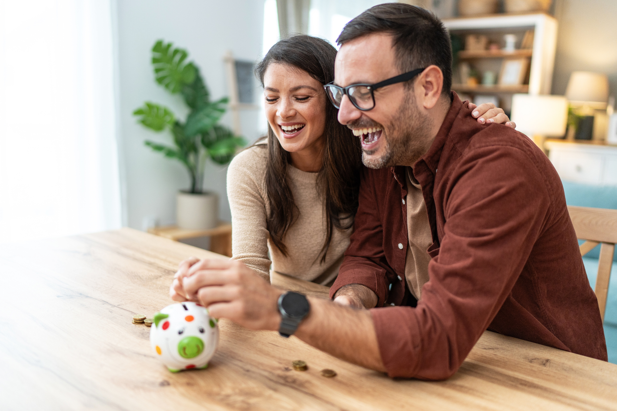 A happy couple celebrating their financial progress and savings milestones.