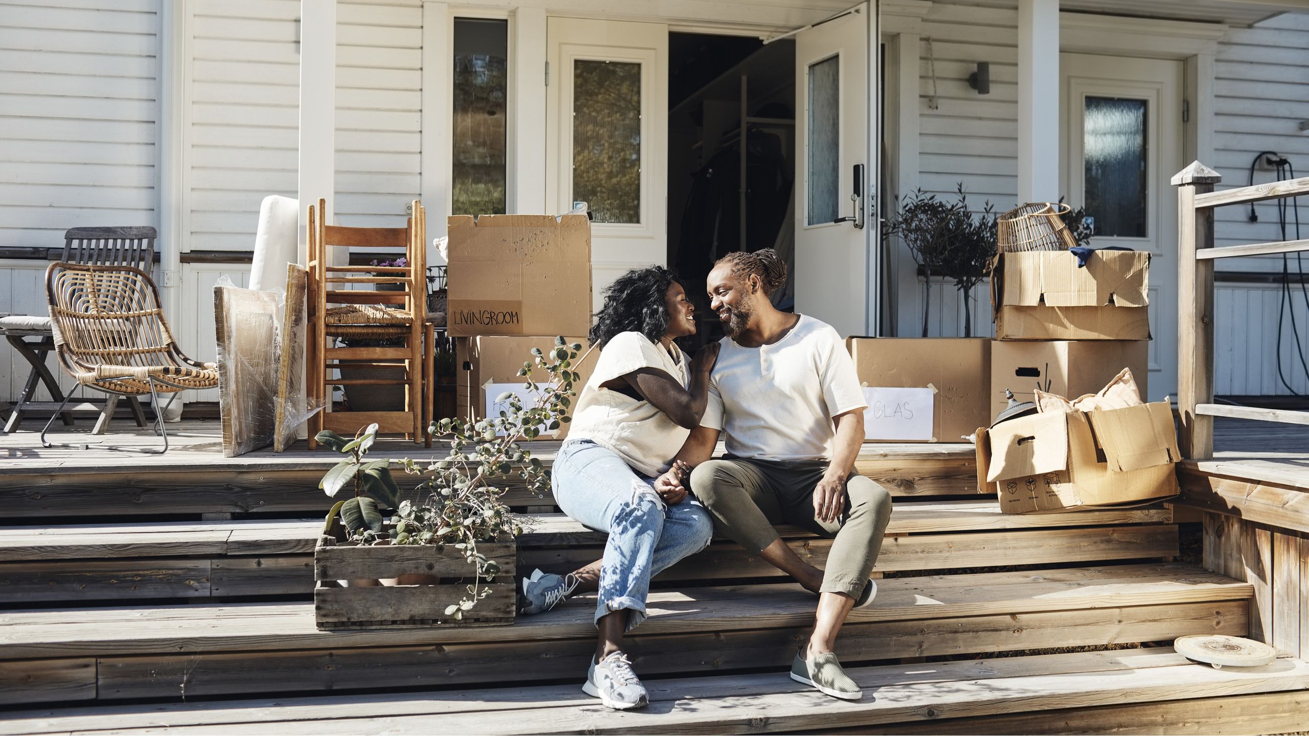 A financial professional discussing housing and investment strategies with a senior client in a bright office environment.