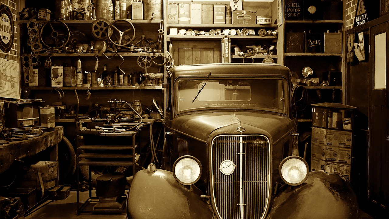 Mechanics inspecting the chassis of a car on a lift in a professional repair facility.