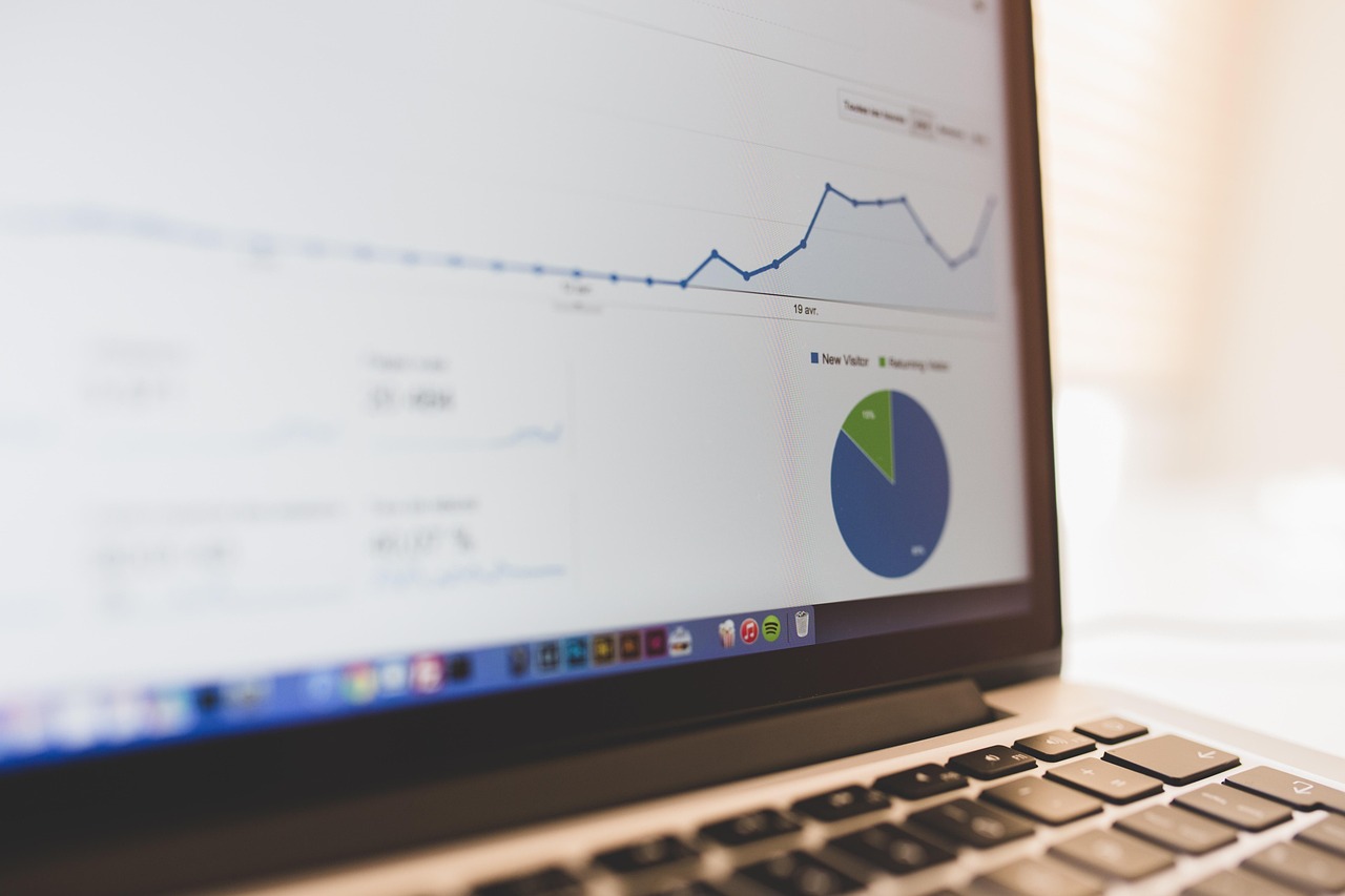 A clean workstation showing a detailed financial spreadsheet on a laptop screen.