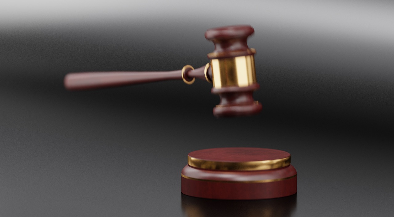 A wooden gavel resting on top of a medical folder
