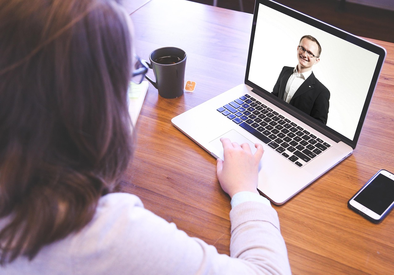 A person attending a video conference with a professional background and good lighting.