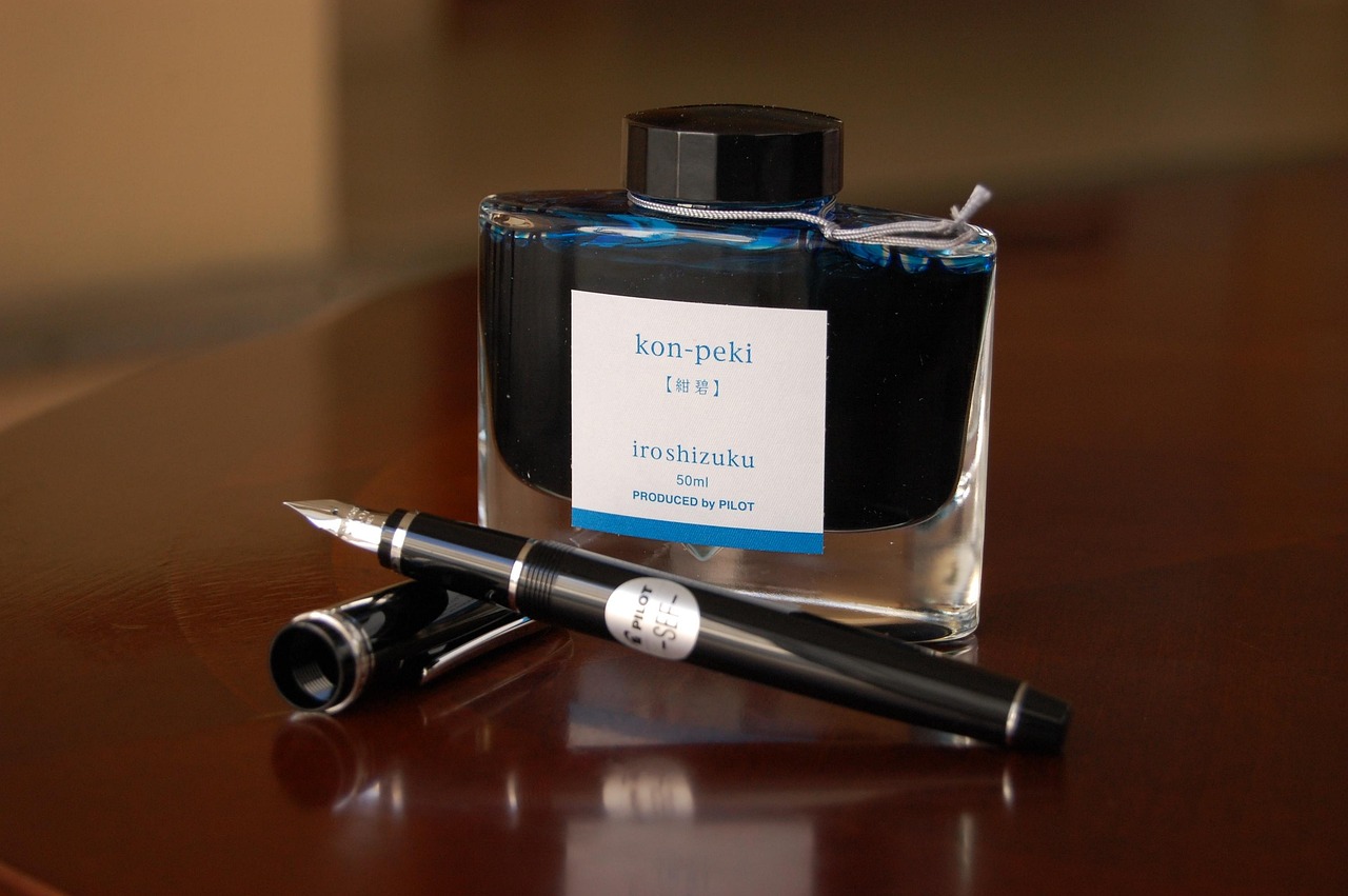 A luxury fountain pen resting on a signed legal agreement or contract.