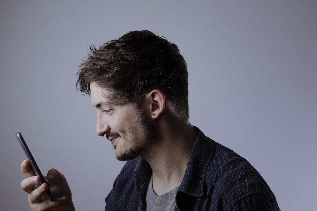 A person feeling stressed while on the phone and looking at a computer