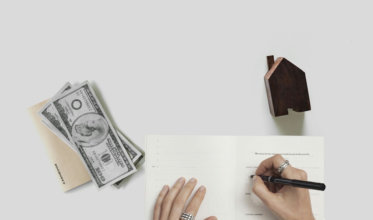 A close up of financial tax forms and a pen, representing administrative compliance.