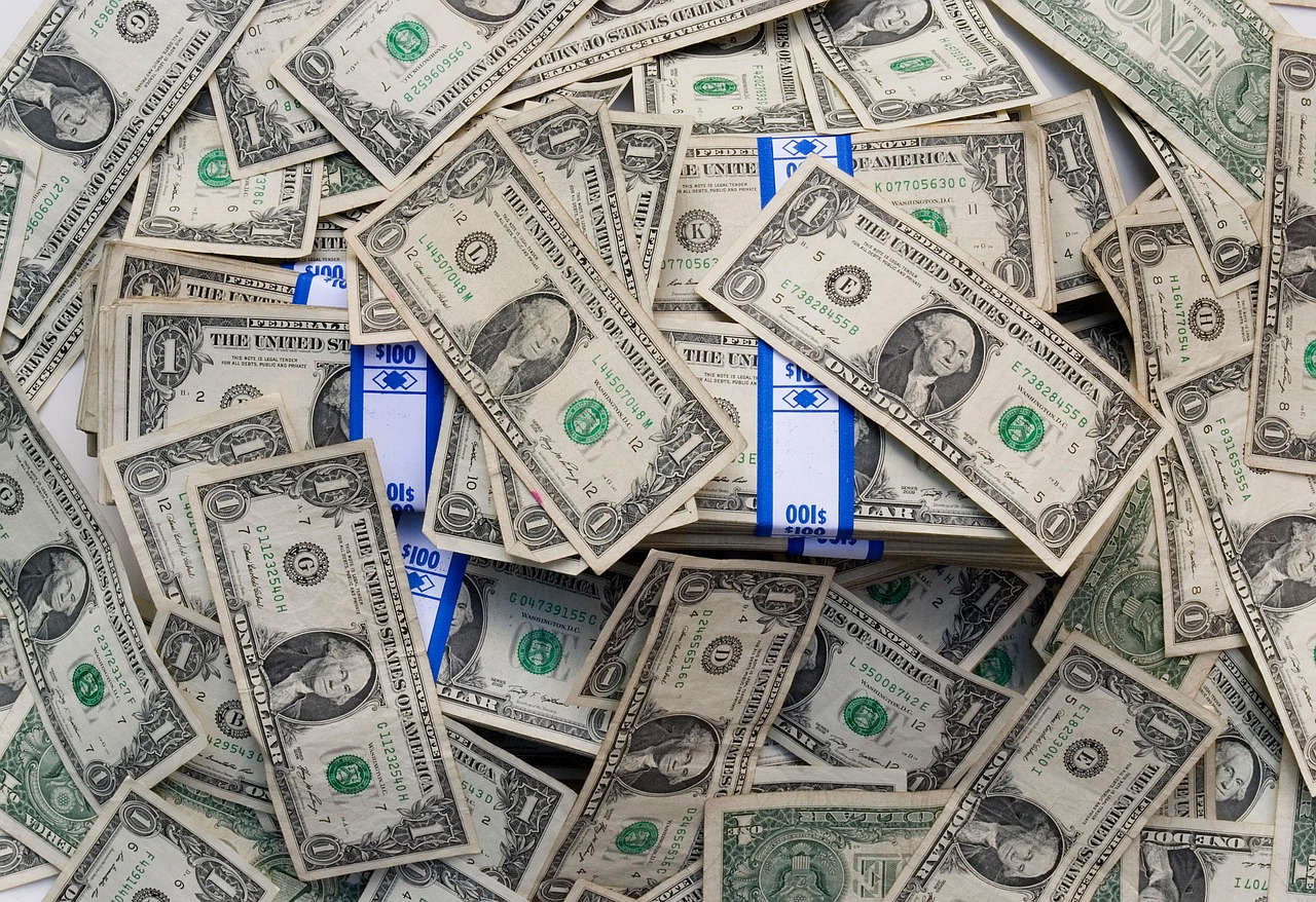 US dollar bills being counted at a retail or currency exchange counter.